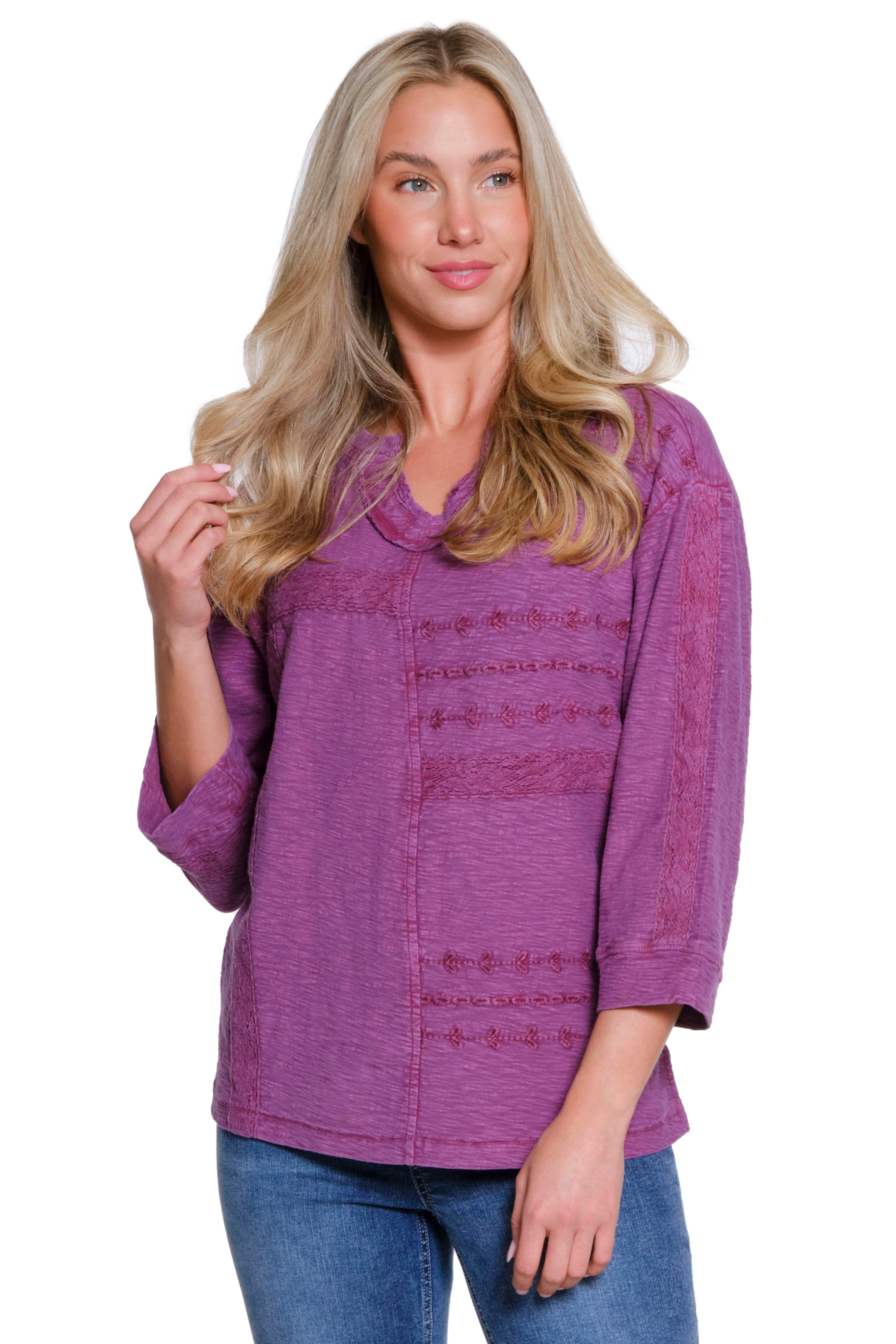 Woman wearing a purple textured shirt on a white background