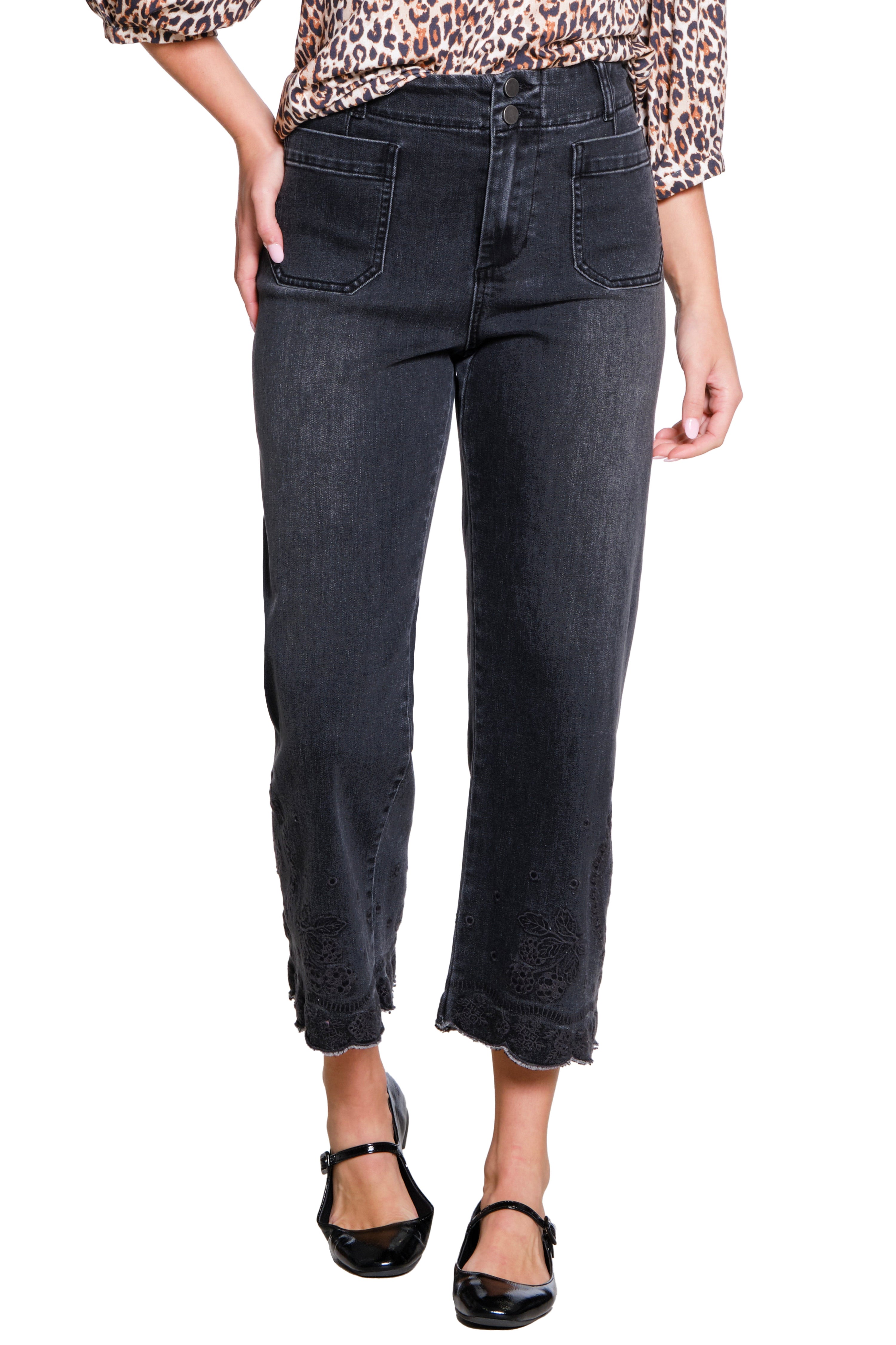 Black jeans worn by a person on a white background