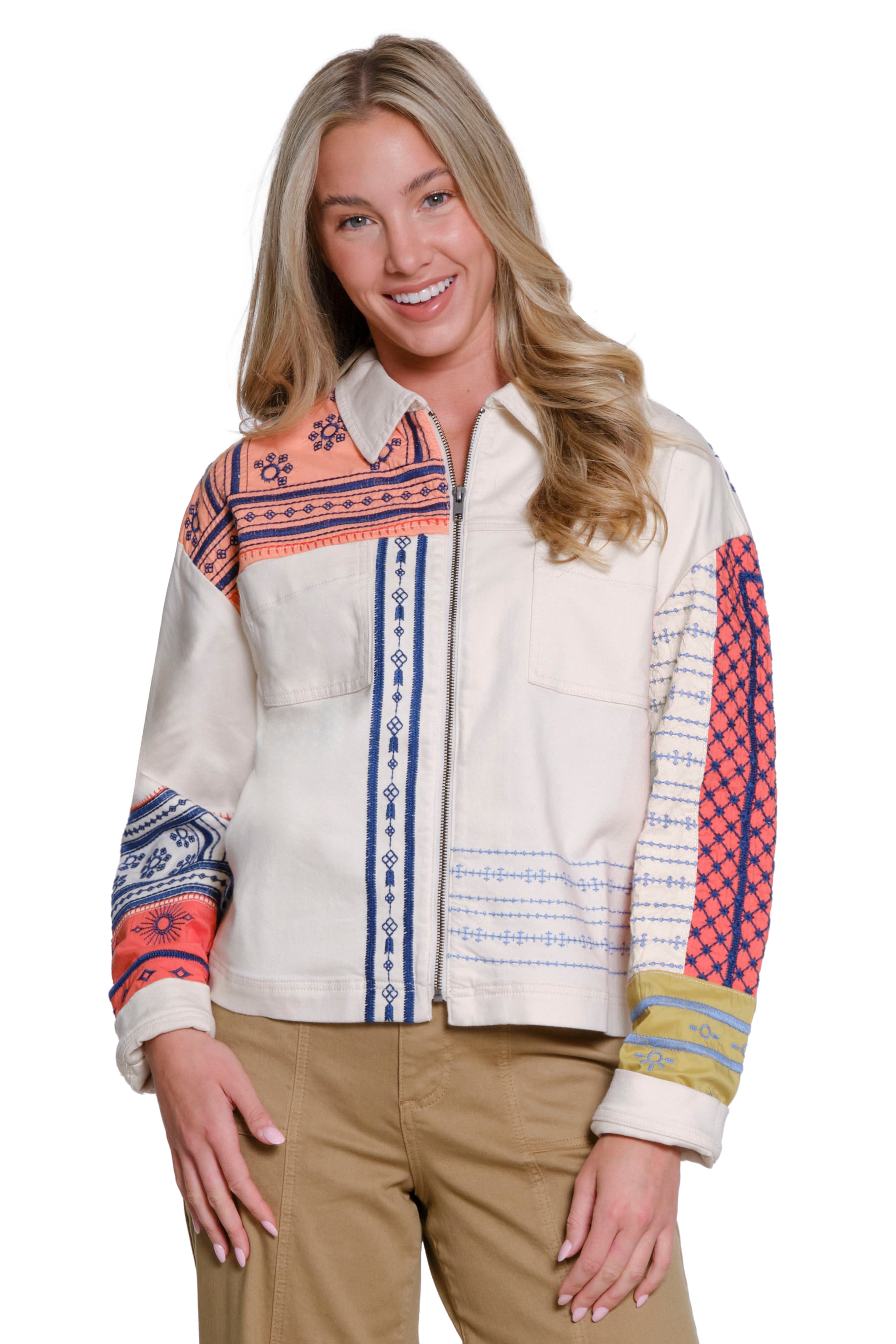 Woman wearing a patterned jacket with a white background